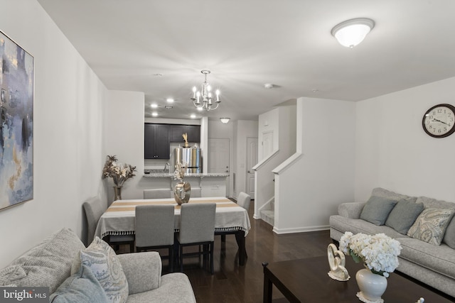 16894 Porters Inn Dr, Dumfries, VA 22026 - living area featuring a chandelier, dark wood-style flooring, and baseboards