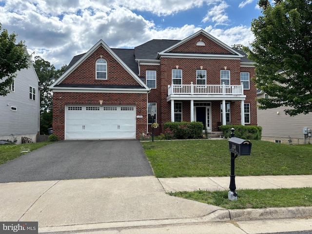 3348 Soaring Cir, Woodbridge, VA 22193 - colonial house with asphalt driveway, brick siding, a front lawn, a balcony, and an attached garage