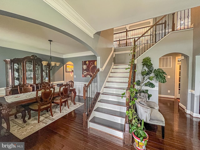 3348 Soaring Cir, Woodbridge, VA 22193 - stairway with arched walkways, crown molding, hardwood / wood-style floors, a chandelier, and wainscoting
