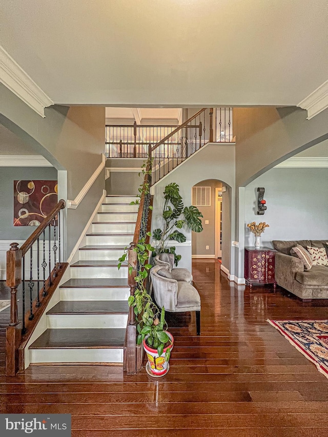 3348 Soaring Cir, Woodbridge, VA 22193 - stairs featuring arched walkways, crown molding, wood-type flooring, and baseboards