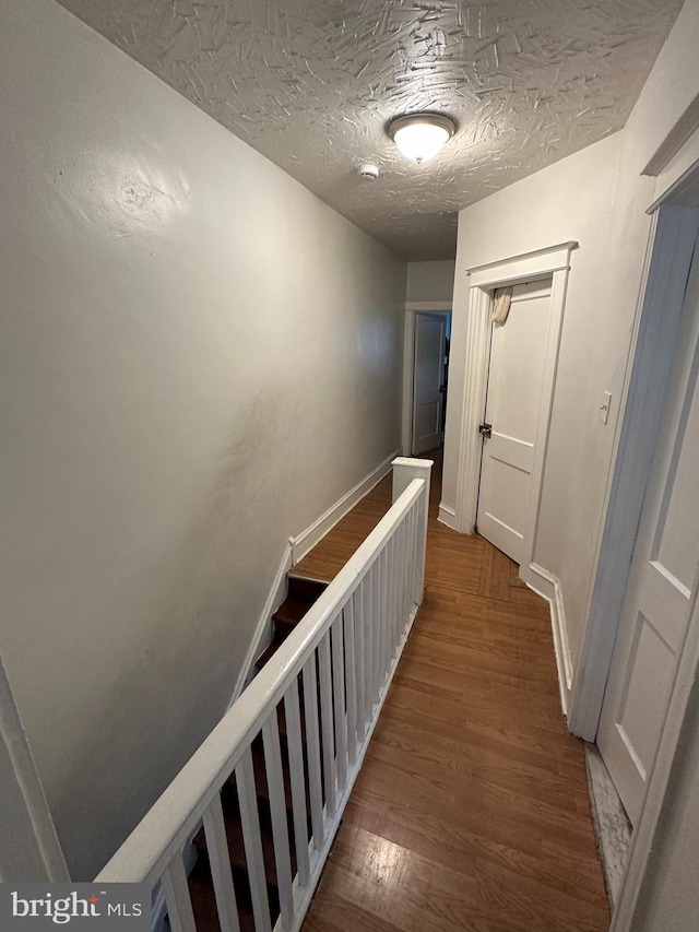 7420 Torresdale Ave, Philadelphia, PA 19136 - hallway featuring wood finished floors, a textured ceiling, and baseboards