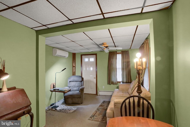 409 Julian St, Williamstown, PA 17098 - living room with a paneled ceiling, a baseboard radiator, a wall mounted air conditioner, and carpet