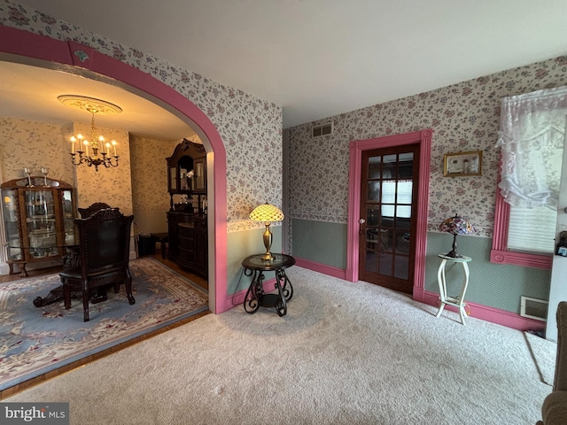 10 E Taunton Ave, Berlin, NJ 08009 - carpeted dining space featuring wallpapered walls, a chandelier, and arched walkways
