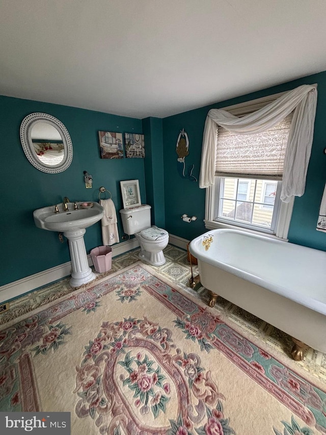 10 E Taunton Ave, Berlin, NJ 08009 - bathroom with a freestanding tub, toilet, and baseboards