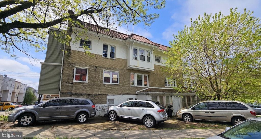 5651 N 16th St, Philadelphia, PA 19141 - view of front facade featuring brick siding and a tiled roof