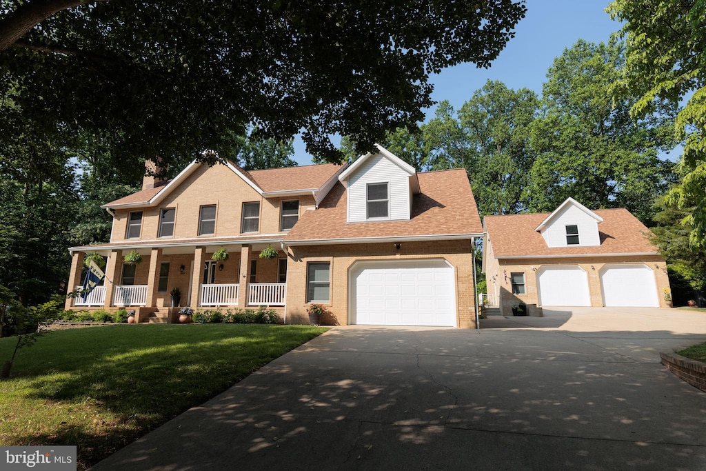 1602 Locksley Dr, Annapolis, MD 21401 - view of front of property with a garage, concrete driveway, covered porch, and a front yard