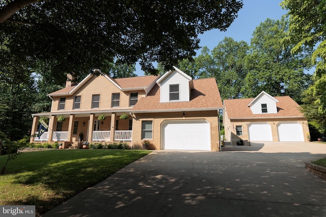 1602 Locksley Dr, Annapolis, MD 21401 - view of front of property with a garage, concrete driveway, covered porch, and a front yard