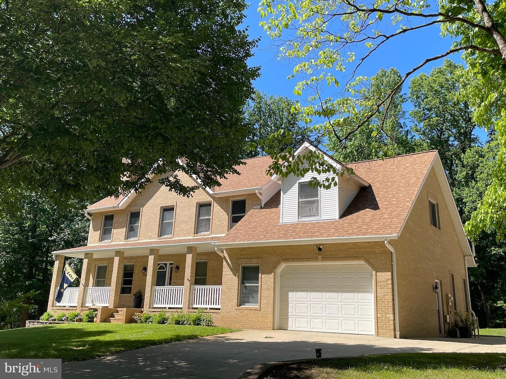 1602 Locksley Dr, Annapolis, MD 21401 - view of front of home with a porch, a garage, driveway, brick siding, and a shingled roof