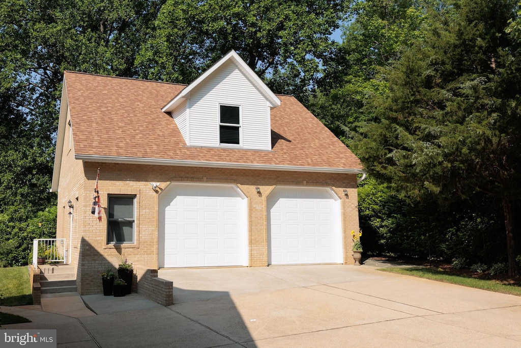 1602 Locksley Dr, Annapolis, MD 21401 - view of front facade featuring brick siding, driveway, a shingled roof, and an attached garage