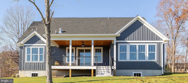 125 Lake Holiday Rd, Cross Junction, VA 22625 - view of front of house featuring roof with shingles, a front lawn, board and batten siding, and a porch