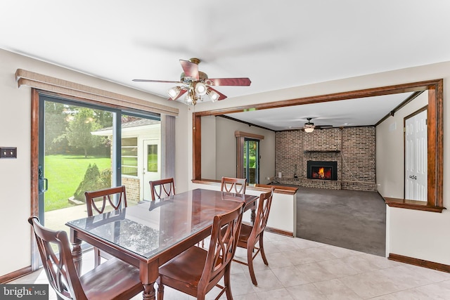 2 Raven Dr, Chadds Ford, PA 19317 - dining space with a ceiling fan, a brick fireplace, light tile patterned floors, baseboards, and light carpet