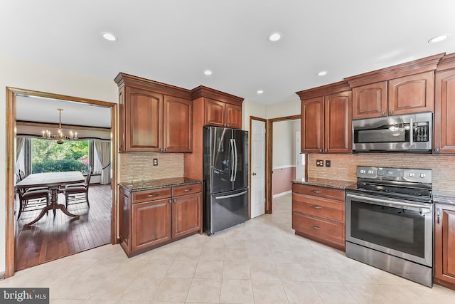 2 Raven Dr, Chadds Ford, PA 19317 - kitchen with stainless steel appliances, a chandelier, dark stone counters, backsplash, and recessed lighting