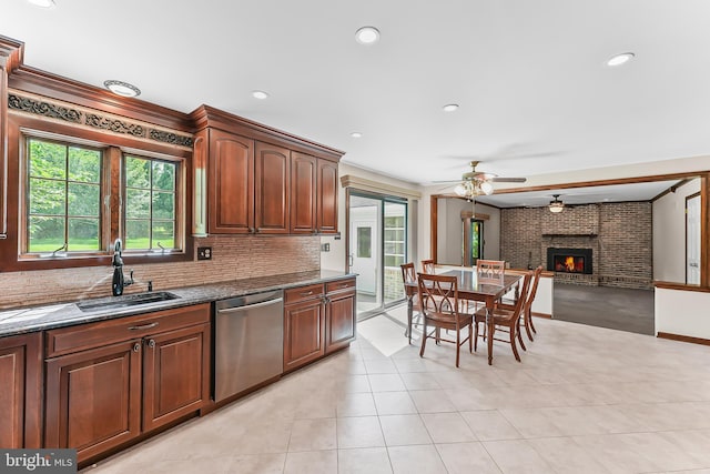 2 Raven Dr, Chadds Ford, PA 19317 - kitchen with dishwasher, a sink, a ceiling fan, dark stone counters, and a fireplace