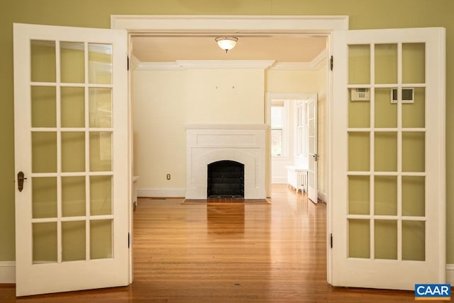 803 Alleghany Ave, Staunton, VA 24401 - unfurnished living room featuring crown molding, wood finished floors, baseboards, and a brick fireplace