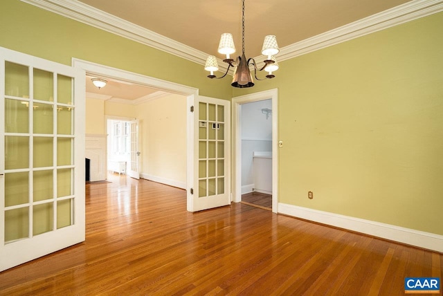 803 Alleghany Ave, Staunton, VA 24401 - unfurnished room with crown molding, a chandelier, baseboards, wood finished floors, and a fireplace with flush hearth