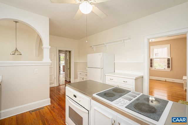 803 Alleghany Ave, Staunton, VA 24401 - kitchen with white appliances, white cabinets, wood finished floors, a ceiling fan, and baseboards