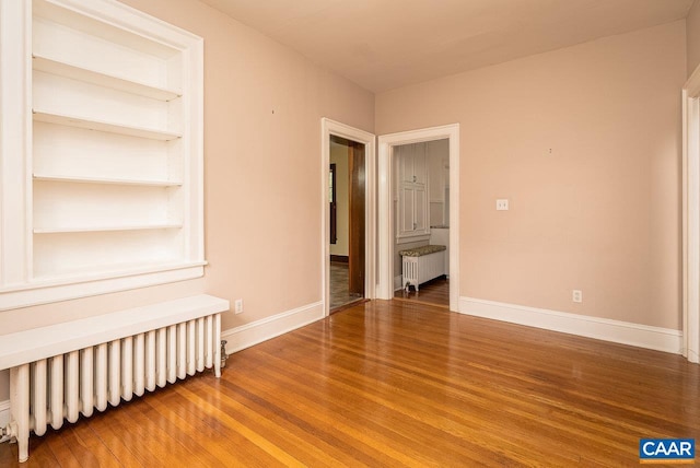 803 Alleghany Ave, Staunton, VA 24401 - spare room with radiator heating unit, wood finished floors, and baseboards