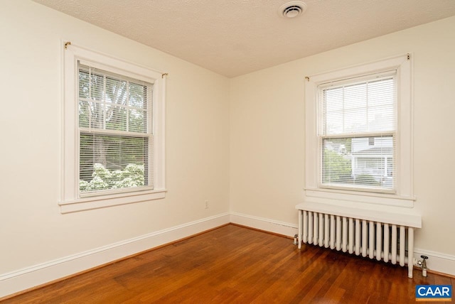 803 Alleghany Ave, Staunton, VA 24401 - unfurnished room with radiator heating unit, healthy amount of natural light, wood finished floors, and baseboards