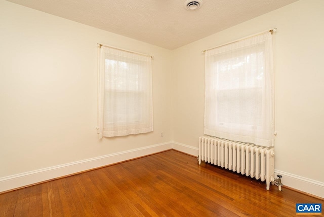 803 Alleghany Ave, Staunton, VA 24401 - empty room featuring radiator, baseboards, and wood finished floors