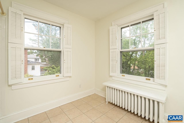 803 Alleghany Ave, Staunton, VA 24401 - empty room featuring baseboards, light tile patterned flooring, and radiator heating unit