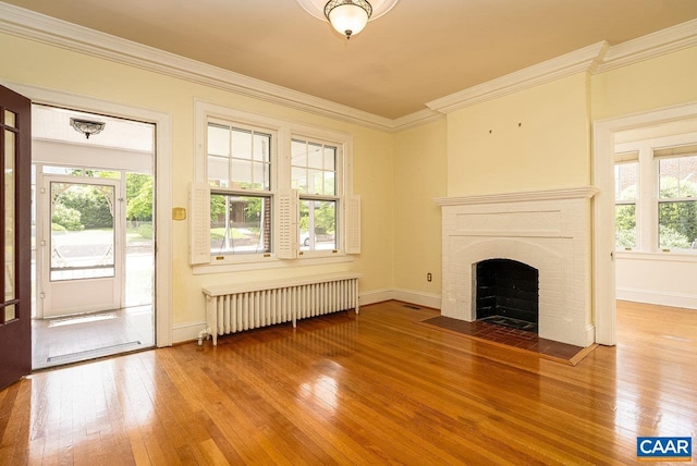 803 Alleghany Ave, Staunton, VA 24401 - unfurnished living room with radiator heating unit, hardwood / wood-style floors, plenty of natural light, and ornamental molding