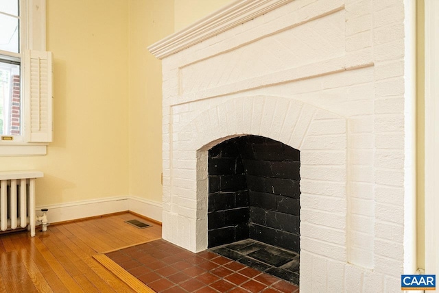 803 Alleghany Ave, Staunton, VA 24401 - detailed view of radiator heating unit, wood finished floors, and baseboards
