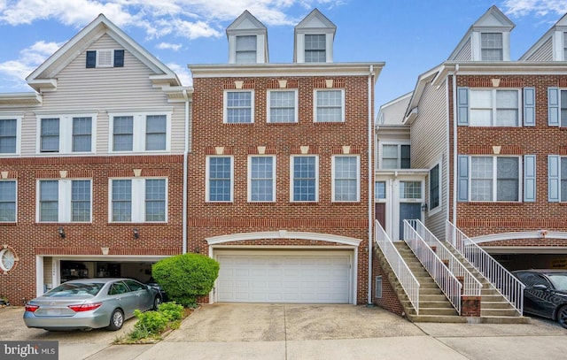 20866 Rockingham Ter, Sterling, VA 20165 - townhome / multi-family property with a garage, brick siding, and concrete driveway