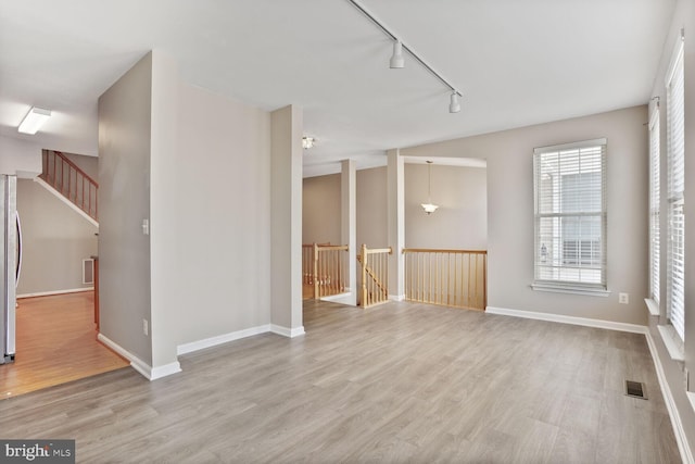 20866 Rockingham Ter, Sterling, VA 20165 - unfurnished room with light wood finished floors, track lighting, and baseboards