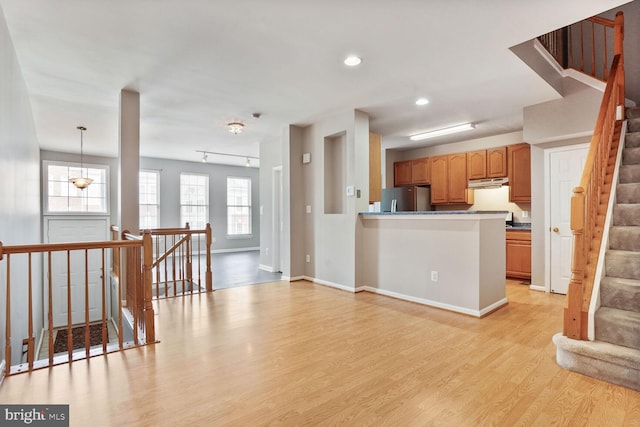 20866 Rockingham Ter, Sterling, VA 20165 - kitchen with freestanding refrigerator, light wood-type flooring, under cabinet range hood, recessed lighting, and baseboards