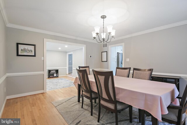4 Old Elm Ct, Lutherville Timonium, MD 21093 - dining space with a chandelier, light wood finished floors, crown molding, and baseboards