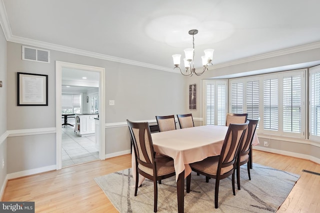 4 Old Elm Ct, Lutherville Timonium, MD 21093 - dining space featuring a chandelier, healthy amount of natural light, light wood-style flooring, crown molding, and baseboards