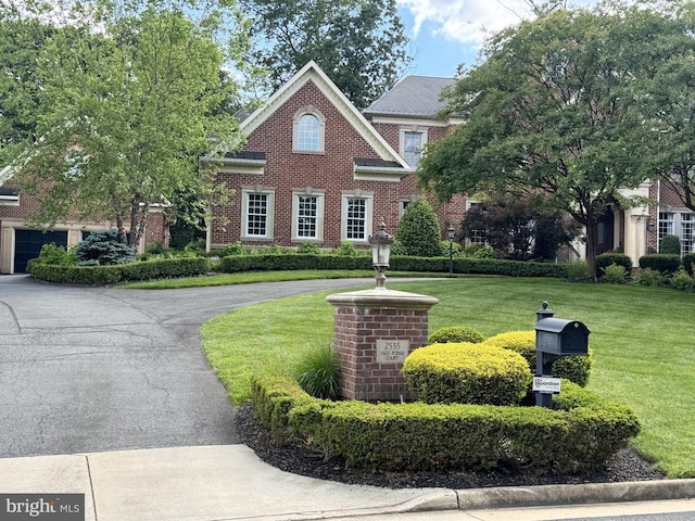 2555 Vale Ridge Ct, Oakton, VA 22124 - colonial house with driveway, a front lawn, and brick siding