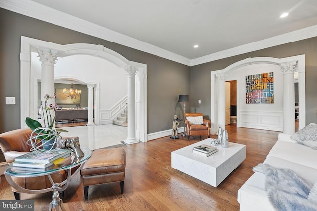 2555 Vale Ridge Ct, Oakton, VA 22124 - living room featuring ornate columns, arched walkways, a decorative wall, wood finished floors, and stairway
