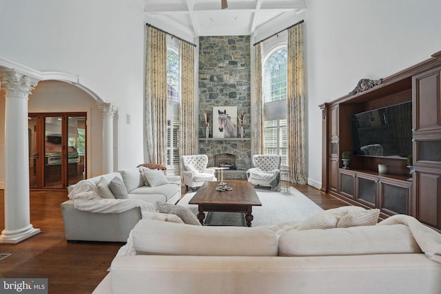 2555 Vale Ridge Ct, Oakton, VA 22124 - living area featuring decorative columns, healthy amount of natural light, a towering ceiling, dark wood-style flooring, and beamed ceiling