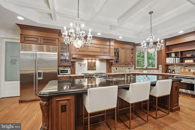 2555 Vale Ridge Ct, Oakton, VA 22124 - kitchen featuring appliances with stainless steel finishes, a chandelier, coffered ceiling, a sink, and backsplash