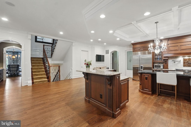 2555 Vale Ridge Ct, Oakton, VA 22124 - kitchen with a chandelier, arched walkways, stainless steel built in fridge, a breakfast bar area, and crown molding