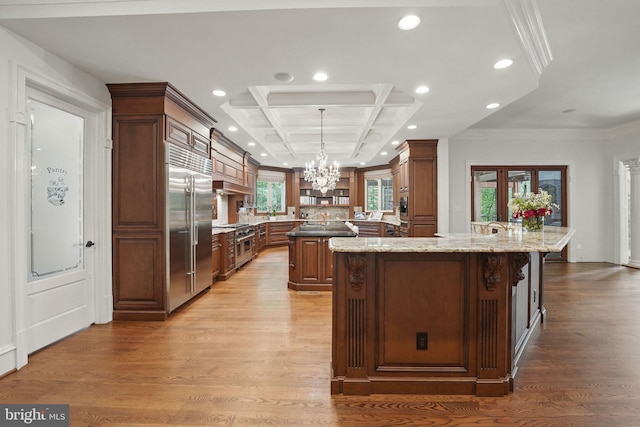 2555 Vale Ridge Ct, Oakton, VA 22124 - kitchen featuring high end appliances, a large island, coffered ceiling, light wood-style floors, and a chandelier