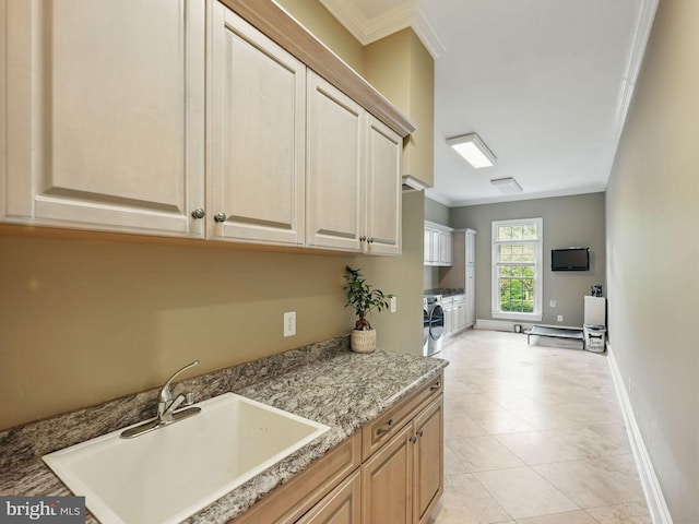 2555 Vale Ridge Ct, Oakton, VA 22124 - kitchen with separate washer and dryer, crown molding, a sink, baseboards, and light tile patterned floors