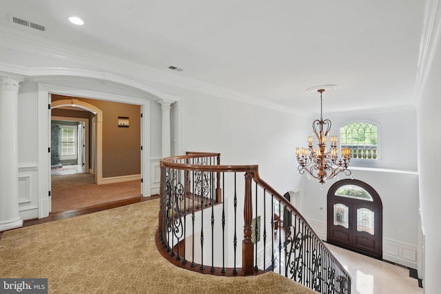 2555 Vale Ridge Ct, Oakton, VA 22124 - entrance foyer with ornamental molding, arched walkways, a chandelier, light wood-type flooring, and ornate columns