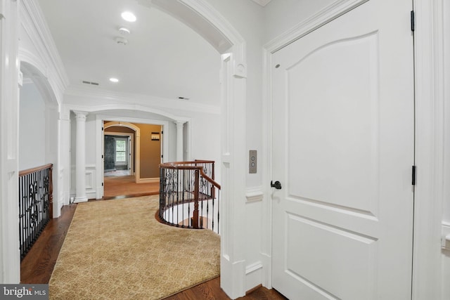 2555 Vale Ridge Ct, Oakton, VA 22124 - hallway featuring arched walkways, ornate columns, dark wood-style floors, ornamental molding, and an upstairs landing