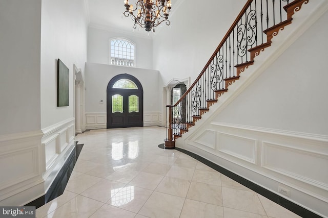 2555 Vale Ridge Ct, Oakton, VA 22124 - entryway with a decorative wall, a chandelier, stairway, ornamental molding, and a towering ceiling