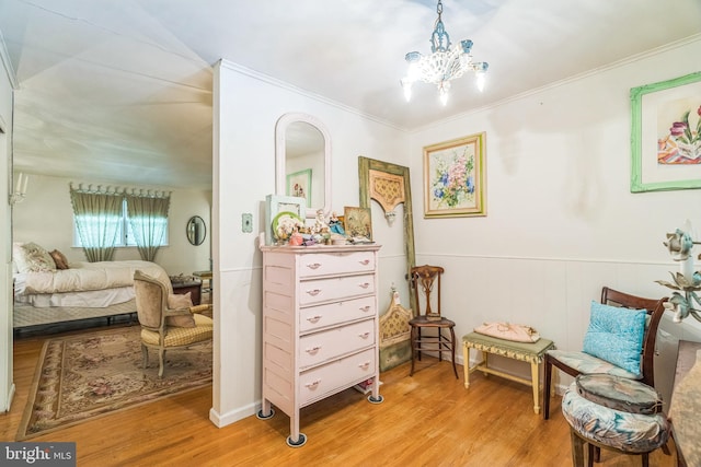 355 Arden, Gulph Mills, PA 19428 - sitting room with light wood-type flooring, a chandelier, wainscoting, crown molding, and arched walkways