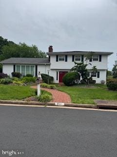 9511 Park St, Manassas, VA 20110 - view of front of home with a chimney and a front lawn