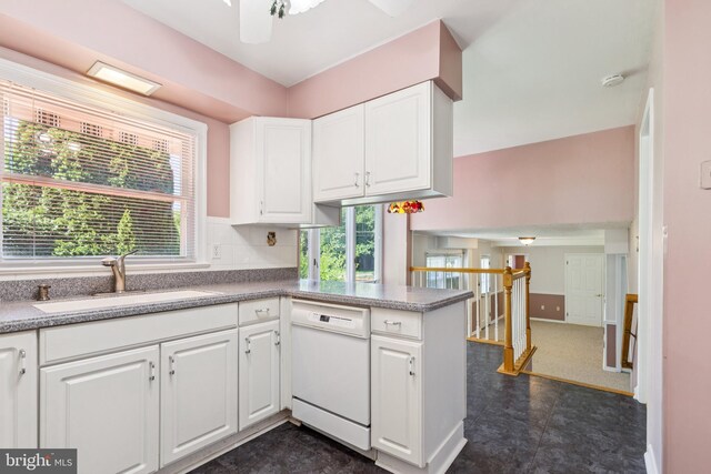 9511 Park St, Manassas, VA 20110 - kitchen with white dishwasher, a sink, white cabinets, a peninsula, and a ceiling fan