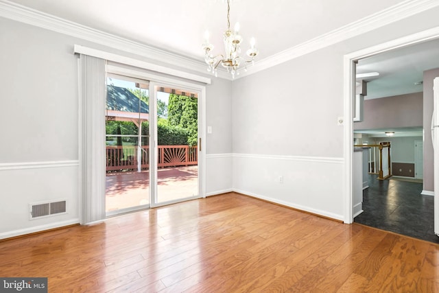 9511 Park St, Manassas, VA 20110 - unfurnished room with a chandelier, wood finished floors, crown molding, and baseboards