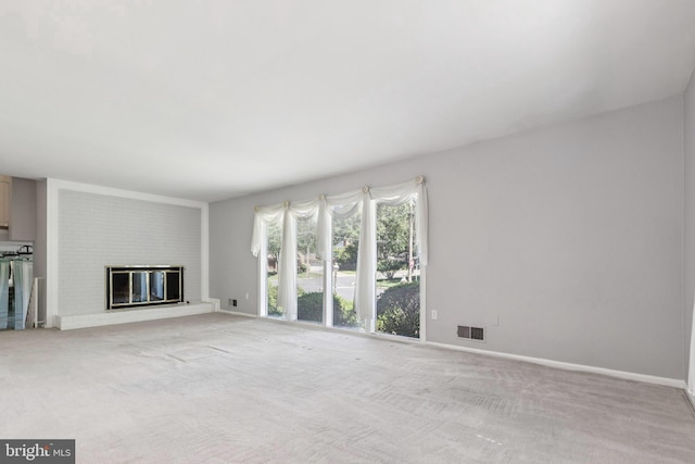 9511 Park St, Manassas, VA 20110 - unfurnished living room featuring light colored carpet, a fireplace, and baseboards