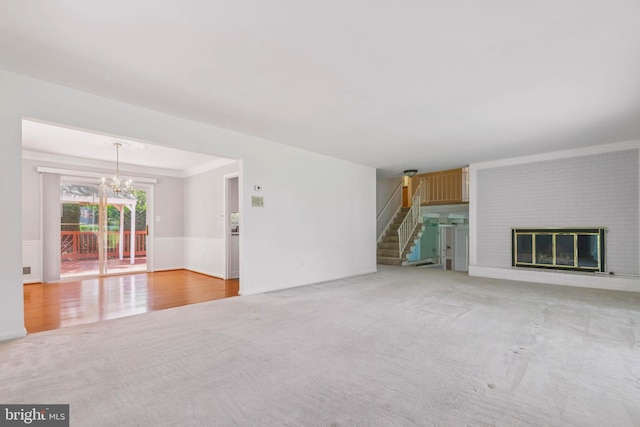 9511 Park St, Manassas, VA 20110 - unfurnished living room featuring carpet flooring, a chandelier, stairway, a fireplace, and ornamental molding