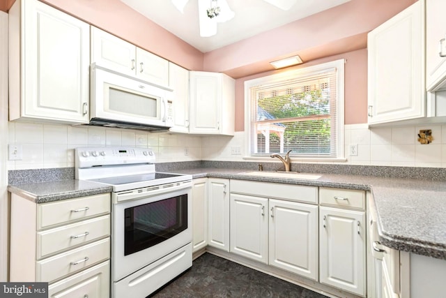 9511 Park St, Manassas, VA 20110 - kitchen with white appliances, a sink, white cabinets, and decorative backsplash