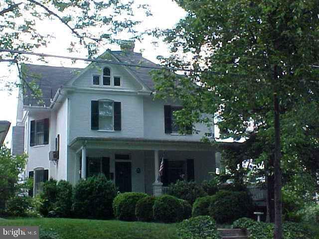 503 S Washington St, Winchester, VA 22601 - view of front of property with stucco siding and a chimney