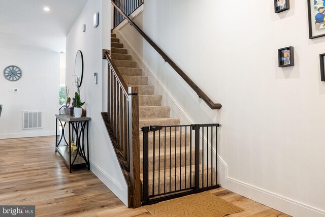 528 N Third St, Martinsburg, WV 25404 - stairs with wood finished floors, baseboards, a towering ceiling, and recessed lighting